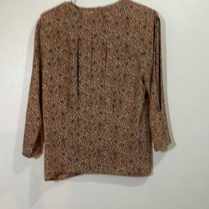 Tess 3/4 sleeved tan blouse with brown, blue and red floral pattern. Size 6
